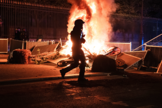 Photos show aftermath of riots as masked groups clash with police across France